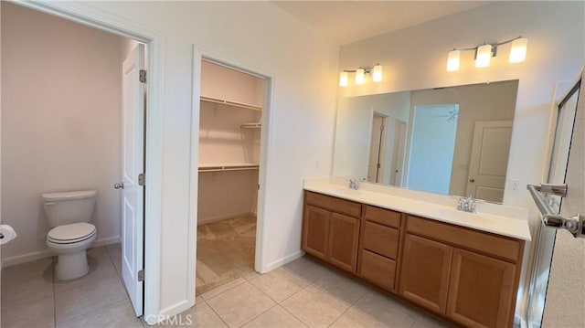 bathroom with tile patterned flooring, vanity, and toilet