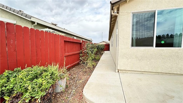 view of side of home with a patio area