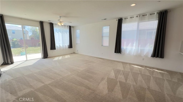 spare room with light carpet and ceiling fan