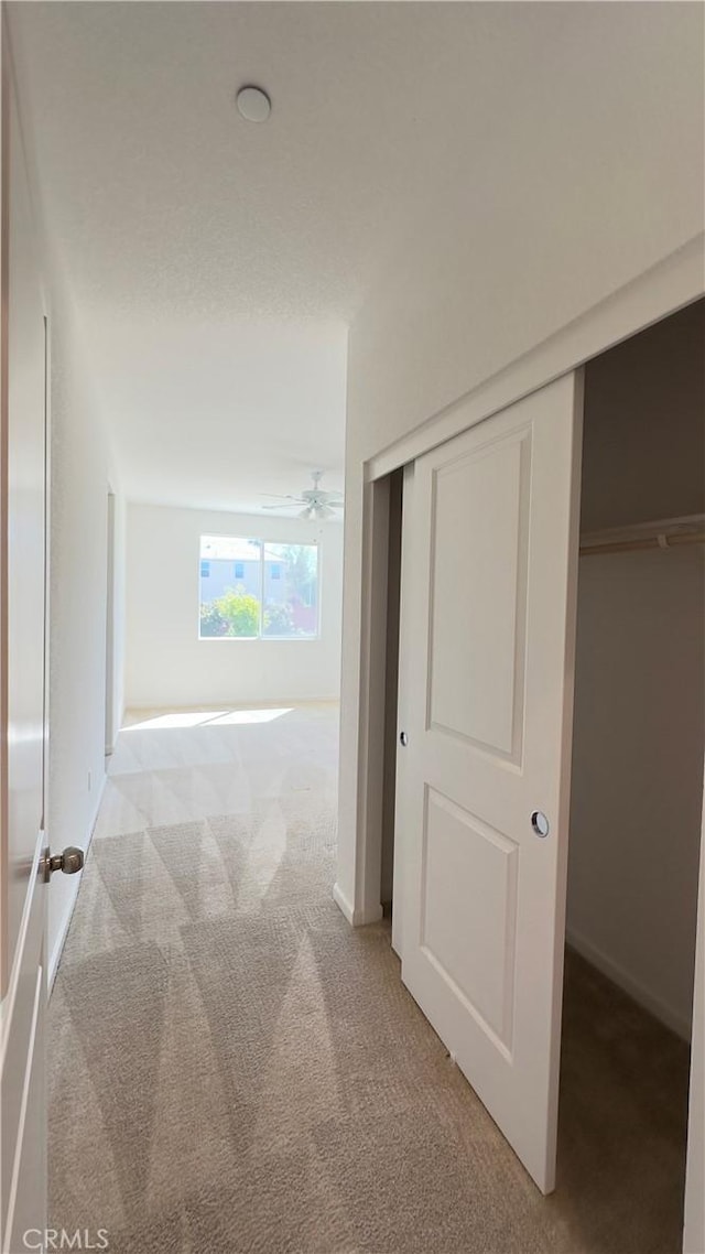 hallway with light colored carpet