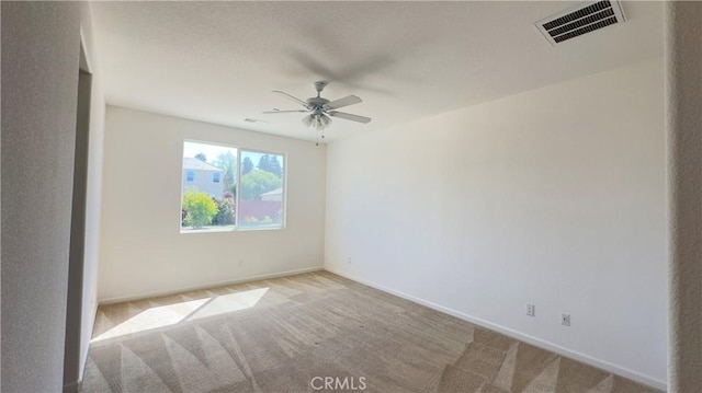 empty room with light colored carpet and ceiling fan