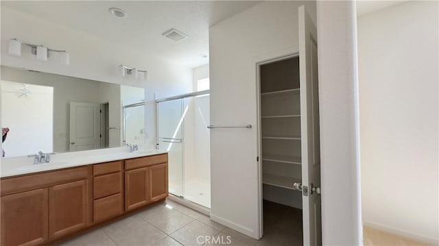 bathroom featuring vanity, an enclosed shower, and tile patterned floors