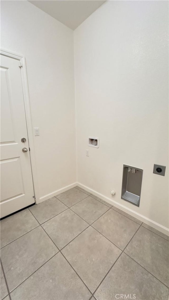 laundry room with light tile patterned floors, hookup for a gas dryer, hookup for a washing machine, and electric dryer hookup