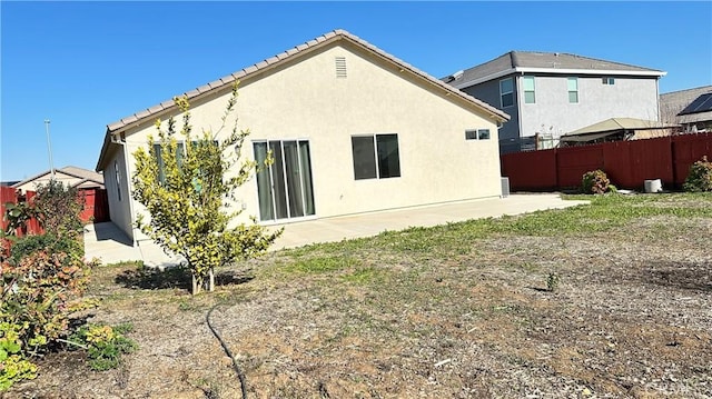 back of house with a patio