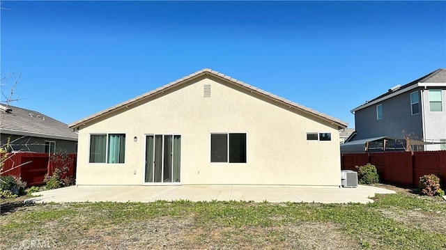 back of property with a patio and cooling unit