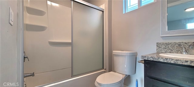 full bathroom featuring combined bath / shower with glass door, vanity, and toilet