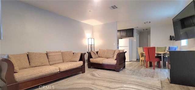 living room with light hardwood / wood-style flooring