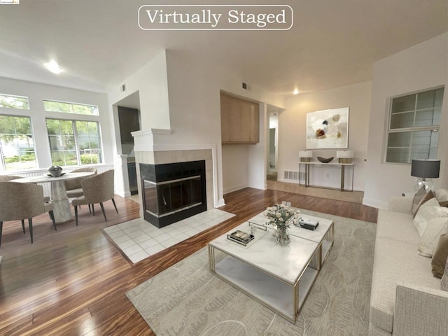 living room with light hardwood / wood-style floors and a fireplace