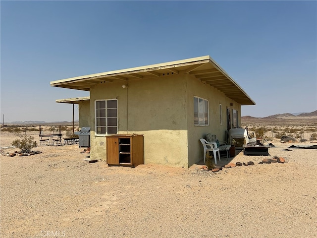 view of side of home with a mountain view