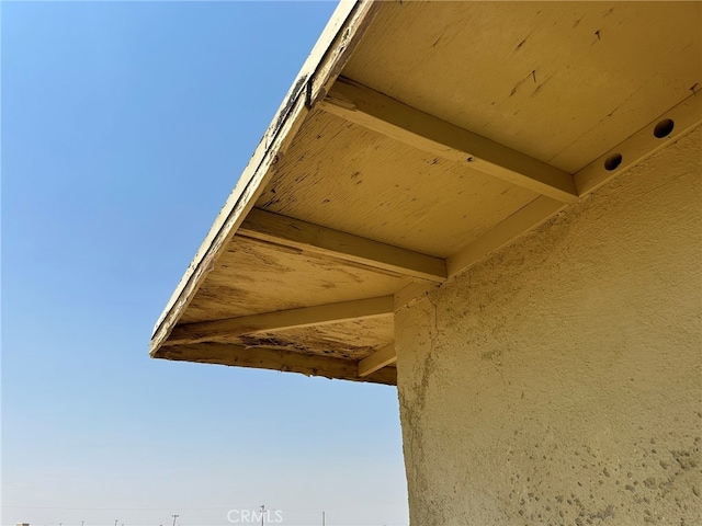 exterior details featuring beamed ceiling