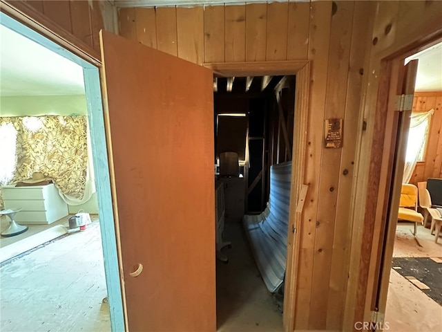 hall featuring wooden walls