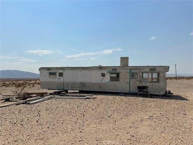 back of house featuring a mountain view