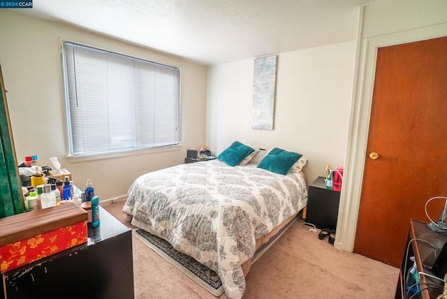 bedroom featuring light colored carpet