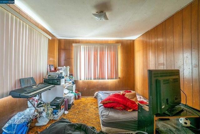 bedroom with wood walls