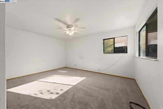 empty room featuring ceiling fan, cooling unit, and carpet