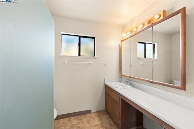 bathroom featuring vanity and toilet