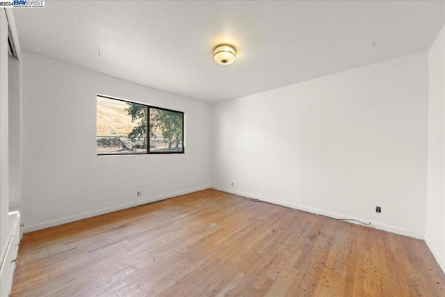 spare room with light hardwood / wood-style flooring