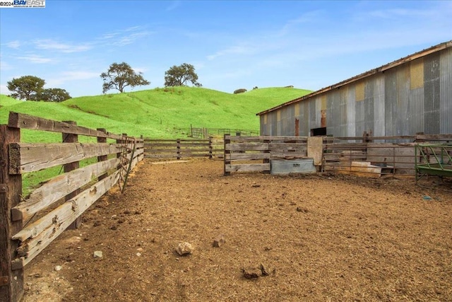 view of yard featuring a rural view and an outbuilding