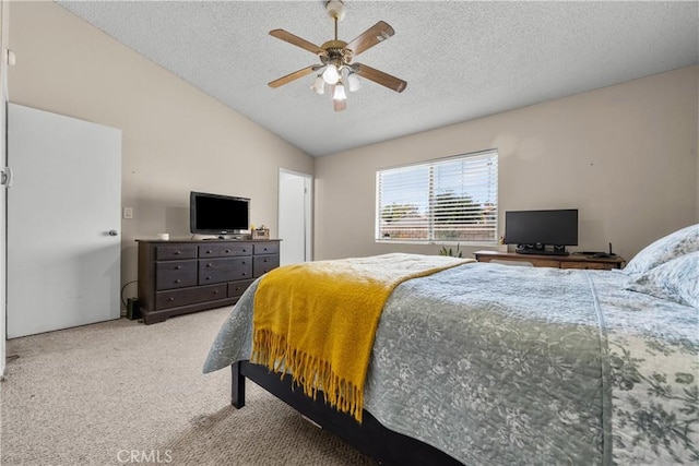 carpeted bedroom with lofted ceiling, ceiling fan, and a textured ceiling