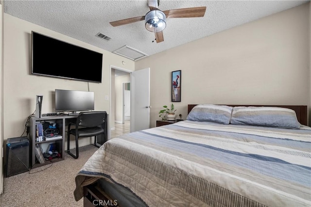 bedroom featuring ceiling fan, light colored carpet, and a textured ceiling