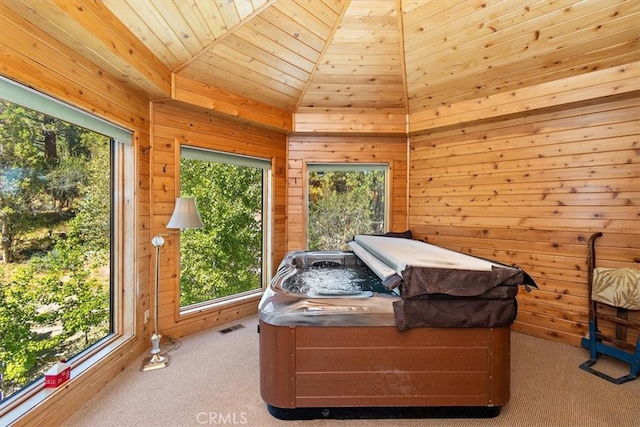 bedroom featuring light colored carpet, wood ceiling, multiple windows, and lofted ceiling