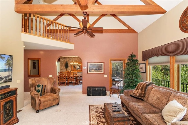 living room with high vaulted ceiling, ceiling fan, beamed ceiling, and carpet flooring