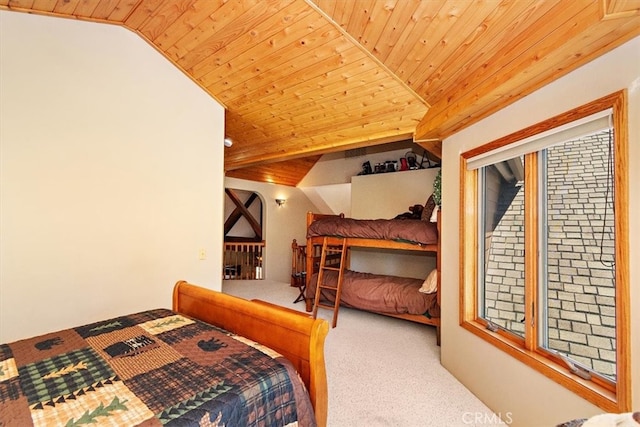 carpeted bedroom featuring wooden ceiling and vaulted ceiling