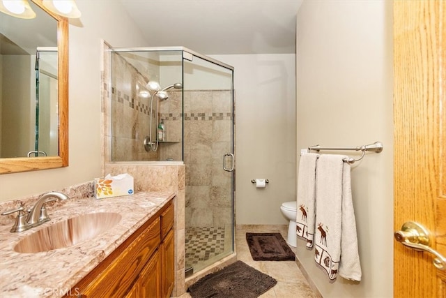 bathroom with vanity, tile patterned floors, an enclosed shower, and toilet