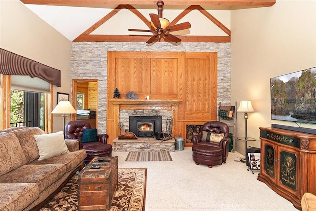 carpeted living room with ceiling fan, beamed ceiling, a fireplace, and high vaulted ceiling