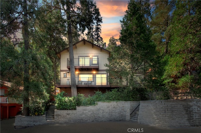 view of front of house featuring a balcony