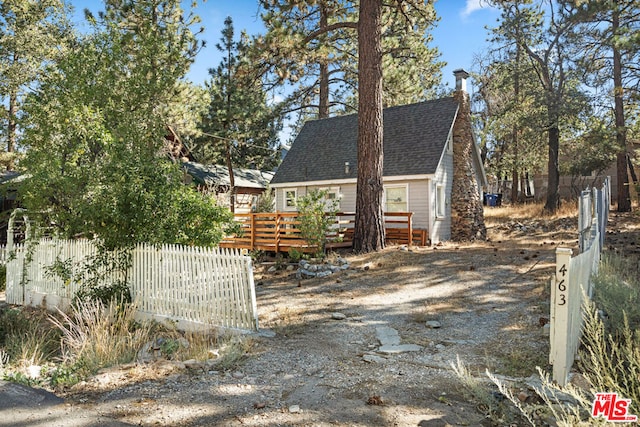 view of side of property with a wooden deck