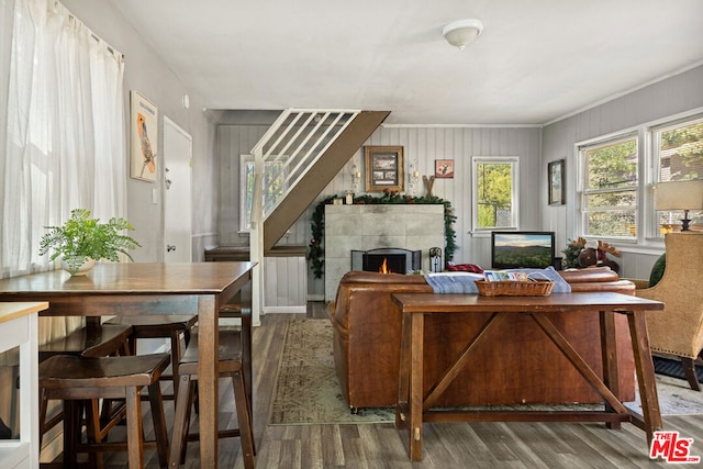 office space with dark wood-type flooring, a fireplace, and crown molding