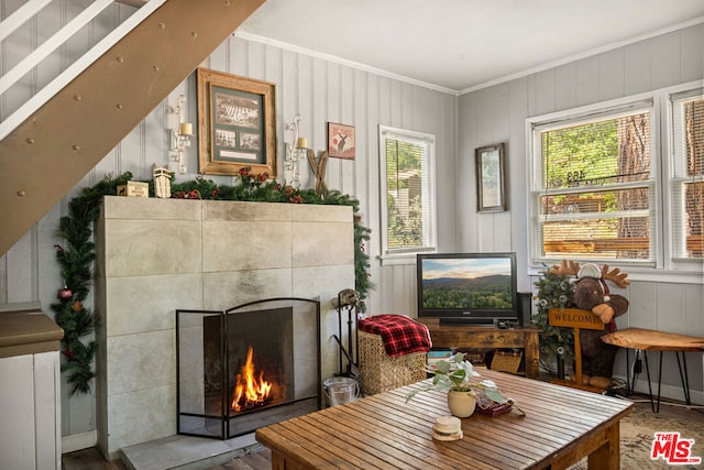 sitting room featuring wood-type flooring and crown molding