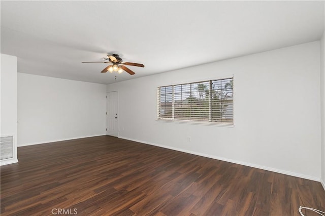 empty room with dark hardwood / wood-style flooring and ceiling fan