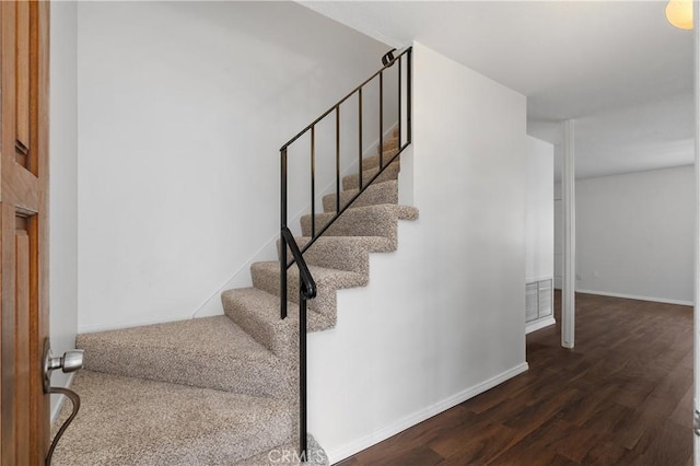 staircase featuring hardwood / wood-style flooring