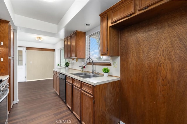 kitchen with dishwasher, dark hardwood / wood-style flooring, sink, and stainless steel range