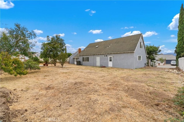 rear view of property with central AC unit