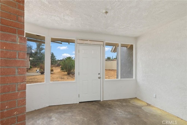 interior space with concrete flooring and a textured ceiling