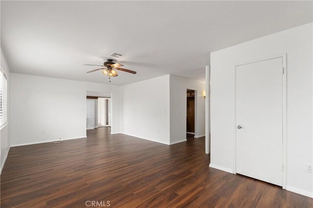 spare room featuring dark hardwood / wood-style flooring and ceiling fan