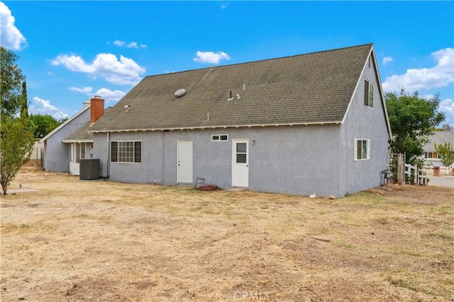 rear view of house with central AC unit