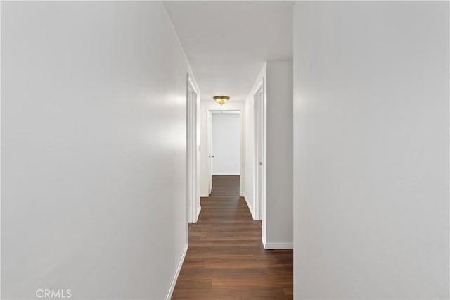 corridor with dark wood-type flooring