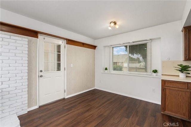 unfurnished dining area featuring dark hardwood / wood-style floors