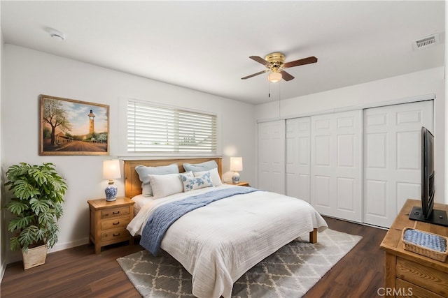 bedroom with a closet, dark hardwood / wood-style floors, and ceiling fan