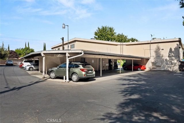 view of parking / parking lot with a carport