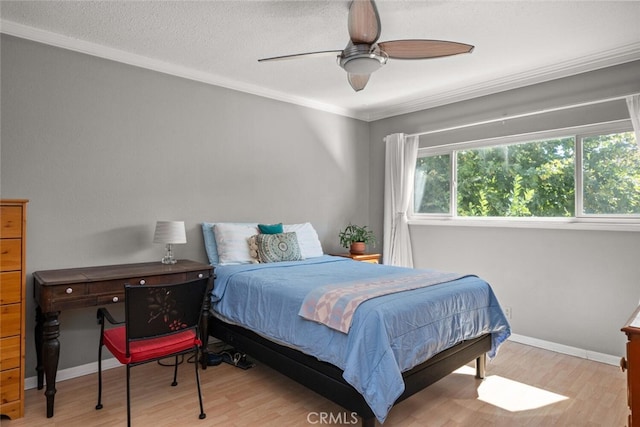 bedroom featuring light hardwood / wood-style flooring, ceiling fan, ornamental molding, and a textured ceiling