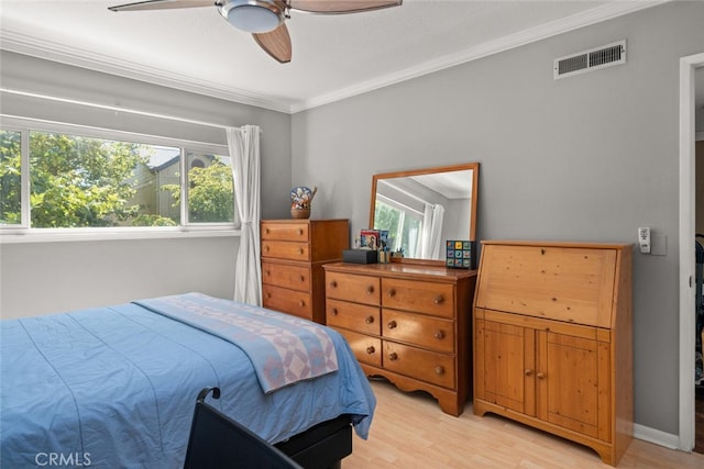 bedroom with multiple windows, light hardwood / wood-style floors, ornamental molding, and ceiling fan