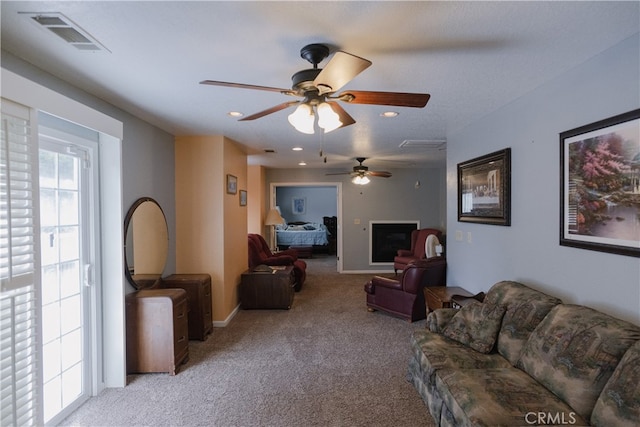 carpeted living room featuring ceiling fan