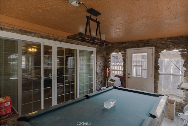 playroom featuring pool table, carpet, and a textured ceiling