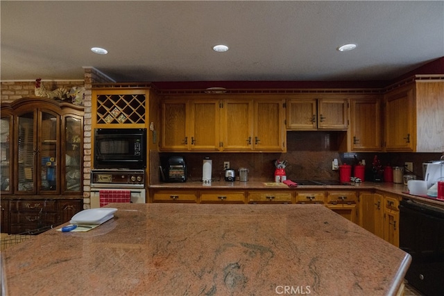 kitchen featuring decorative backsplash and black appliances