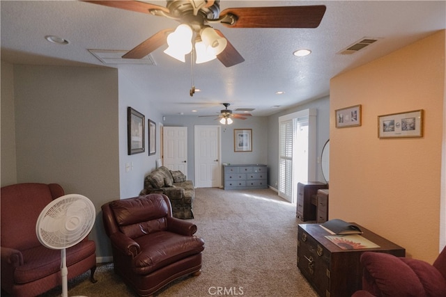 living room with ceiling fan and carpet